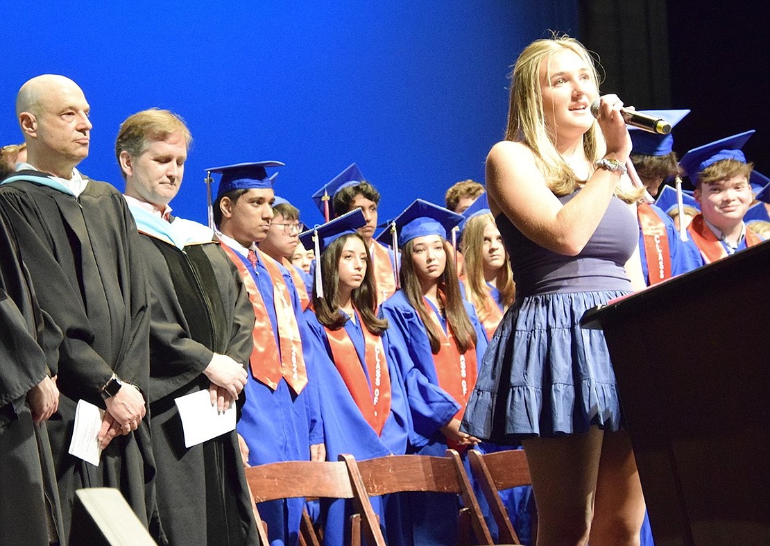 Then Blind Brook High School junior Abby Meron momentarily joins the Class of 2024 on the stage to sing “The Star-Spangled Banner.”