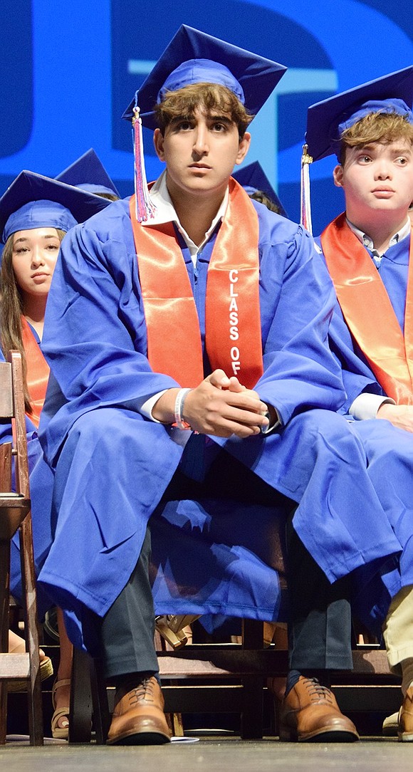 Eduardo Almeida-Jarufe stares off into the crowd of loved ones in the audience as presenters share parting words of wisdom.