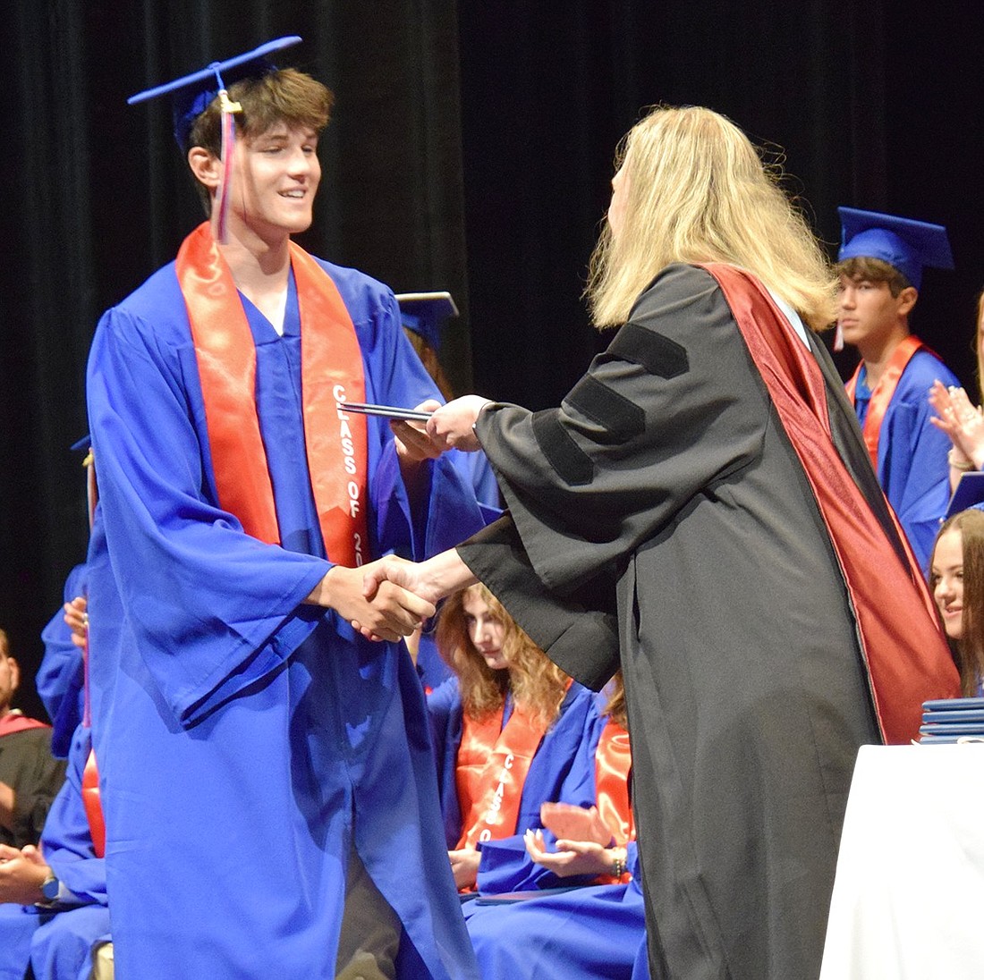 Blind Brook High School Class of 2024 top scholar Joaquin Otero smiles as he receives his diploma from Principal Jennifer Chirles during commencement on June 20. Otero will be attending Northwestern University in the fall.