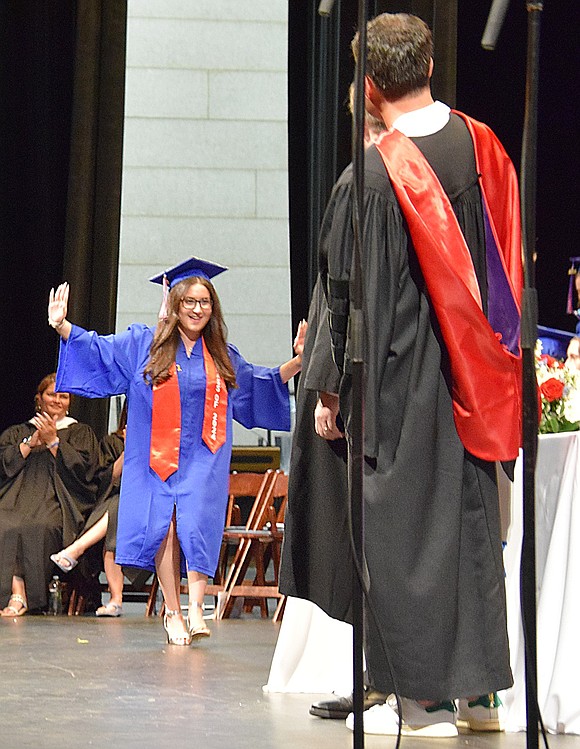 Can you tell Ella Piacente is pumped? Theatrically welcoming the cheers, she dances after her name is called and she can strut across the stage to receive her diploma.