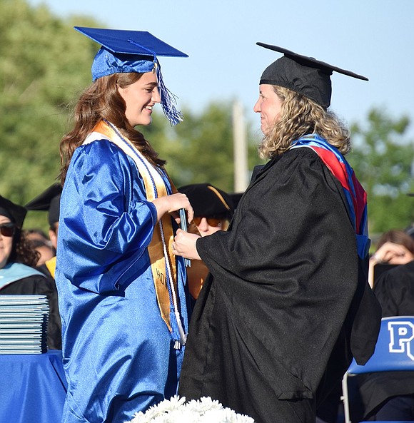 Emotion is felt across the stadium as Board of Education Vice President Sharon Burke gets called up to give her daughter Allegra her diploma.