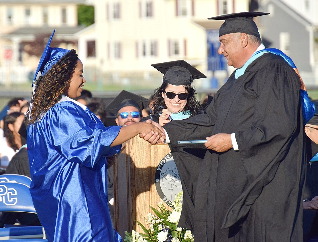 With elegance and grace, Frances Fevrier marches up to Assistant Superintendent of Business Philip Silano to accept her degree along with a handshake.