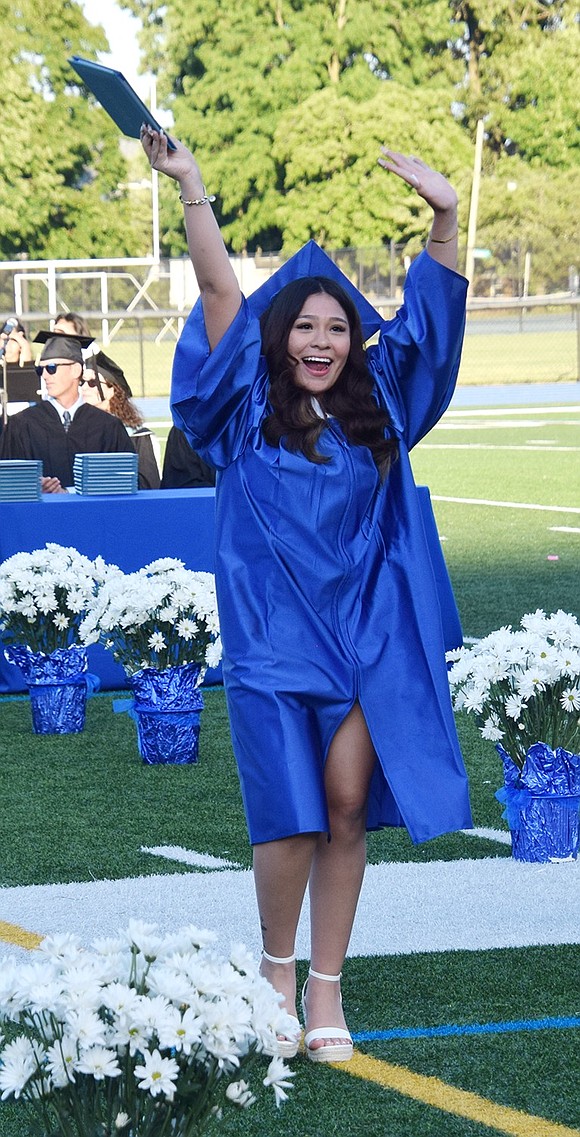 With a degree in hand, Sashenka Herrera is ready to party. She dances down the aisle as one of the newest Port Chester High School alumnae.