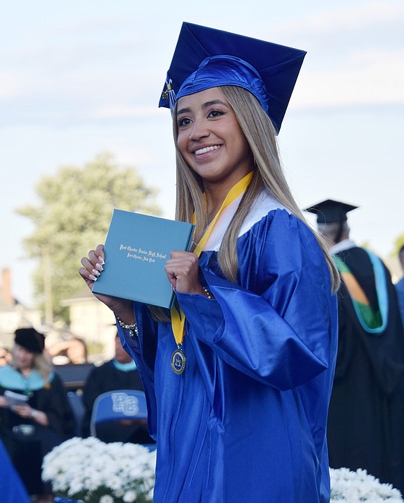 Excitement radiates behind Cindy Laynes’s soft smile as she holds her diploma, taking a beat before walking back to her seat.