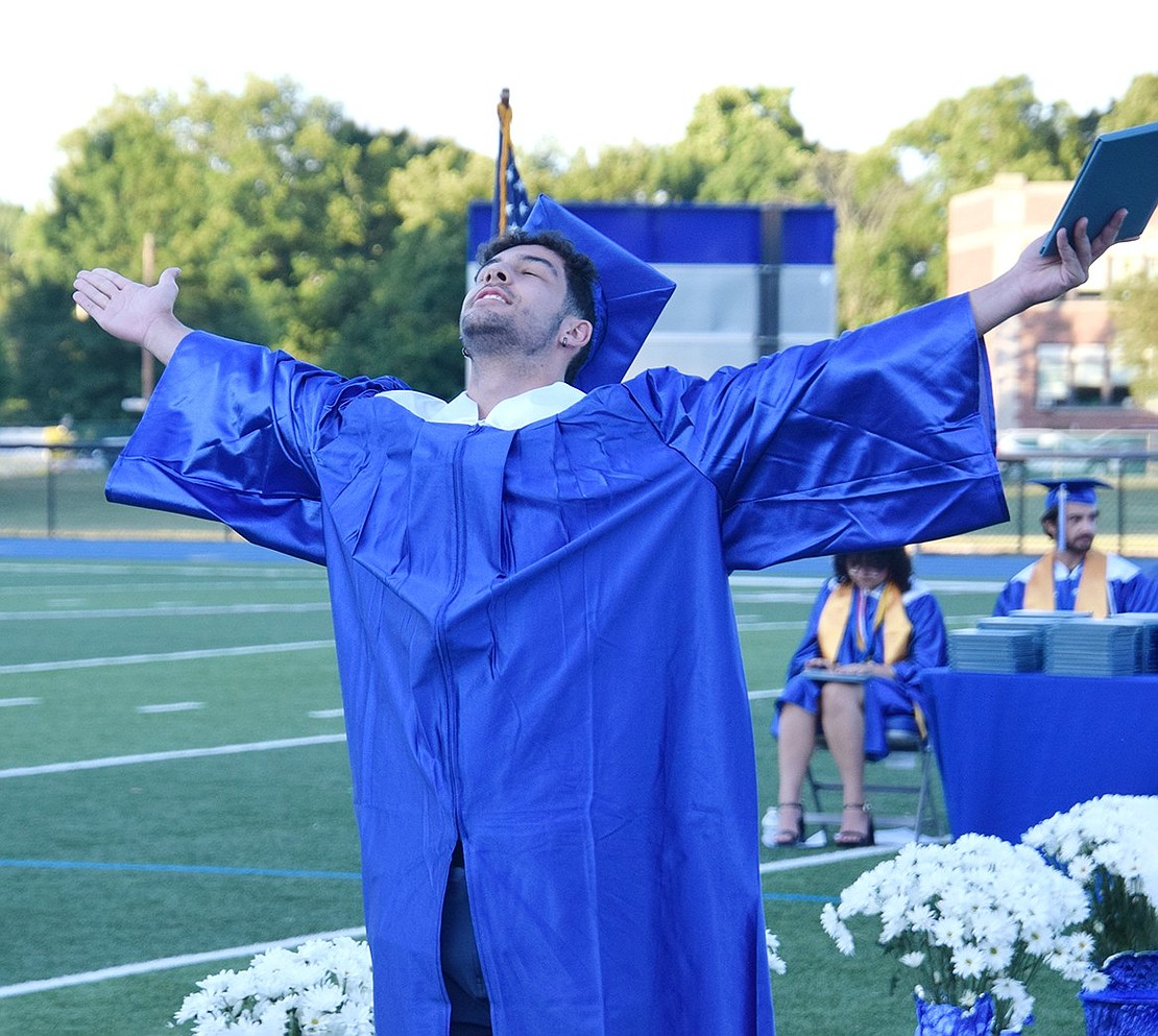 Free at last, Pedro Goncalves faces the sky as he grasps his degree, embracing the moment he becomes a Port Chester High School graduate.