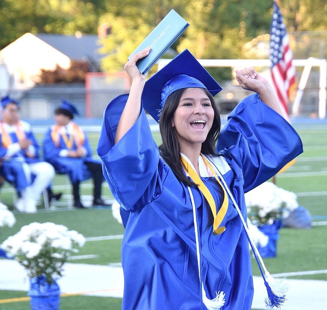 The Class of 2024 are students no more! Andrea Vargas cheers toward loved ones after she gracefully accepts her degree.