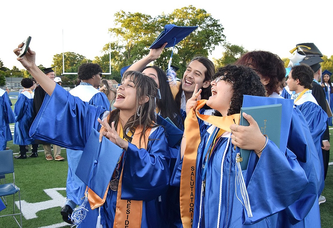 Friends gather around Ava Osorio as she takes a group picture in celebration of their big accomplishment.