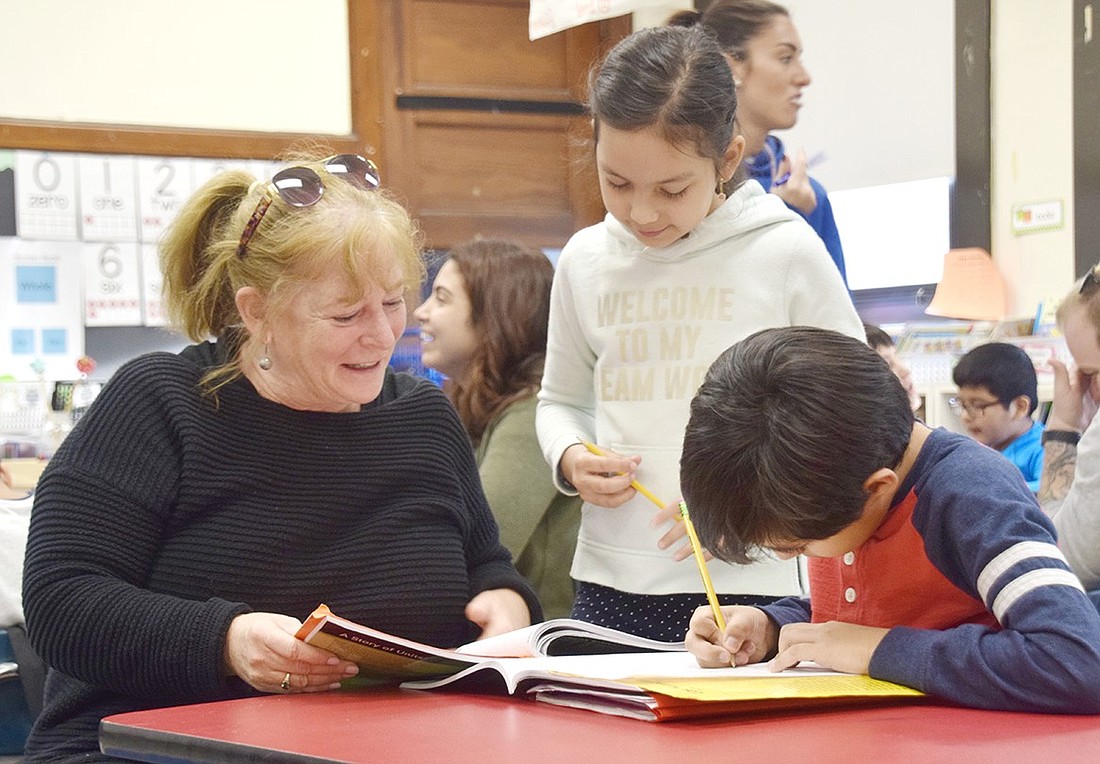 In January 2020, Port Chester Schools teaching assistant Rose Pueraro, who was also employed by the Carver Center for its afterschool program, helps Edison School students with math problems. In the 2024-25 school year, the community center will return to the schools to facilitate an enrichment program at a more affordable cost than offered the year before.