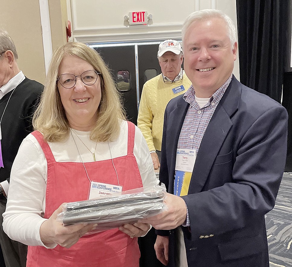 Jananne Abel, editor of the Westmore News, accepts a first-place plaque for Coverage of Local Government from Terry Tuthill, president of the New York Press Association board of directors, at the NYPA Spring Conference in Saratoga Springs on Apr. 26.