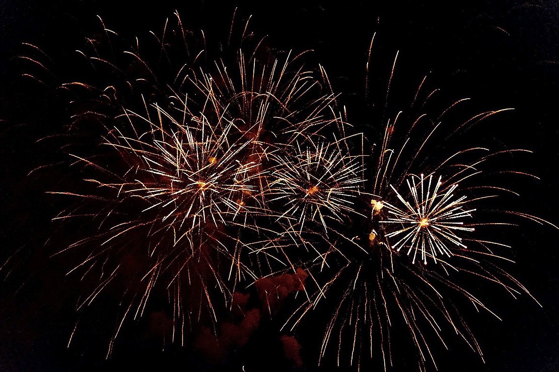 Fireworks dance across the sky over the field at Port Chester High School on the Fourth of July.