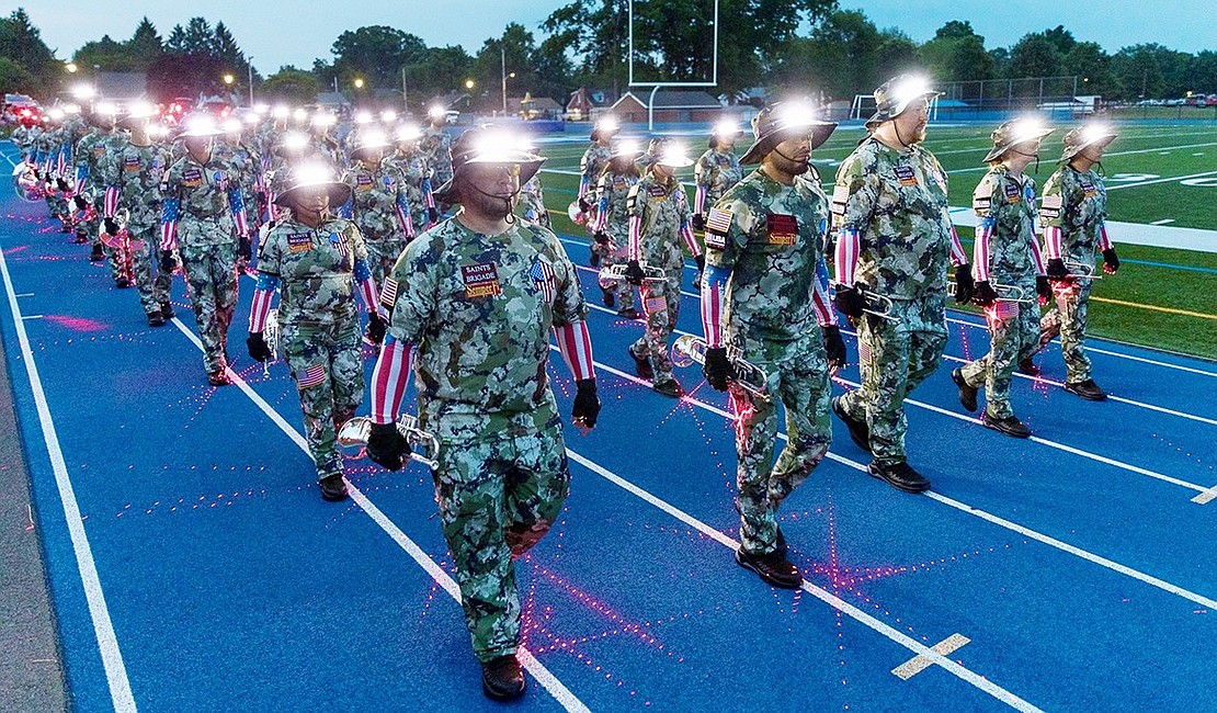 The Saints Brigade exits the field with white lights on their hats and pink lights on their pants creating an interesting effect.