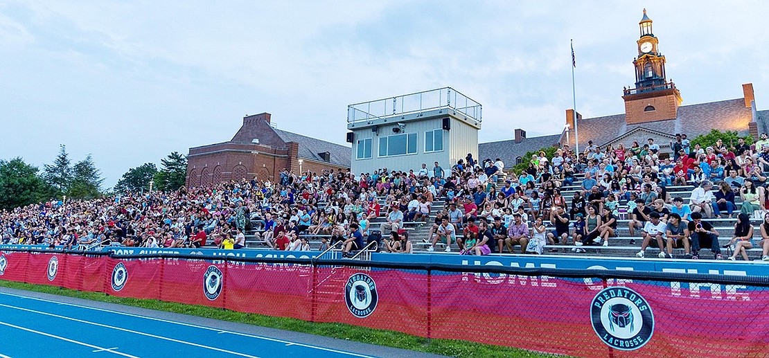 The stands at Ryan Stadium start to fill up as the time on the Port Chester High School clocktower inches closer to 9 p.m.