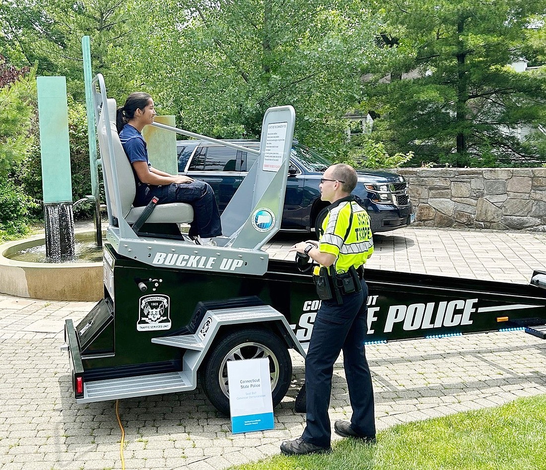 Connecticut State Police set up a seatbelt convincer for an attendee at Greenwich Hospital’s event celebrating its designation as a Level III Trauma Center on Sunday, June 23.