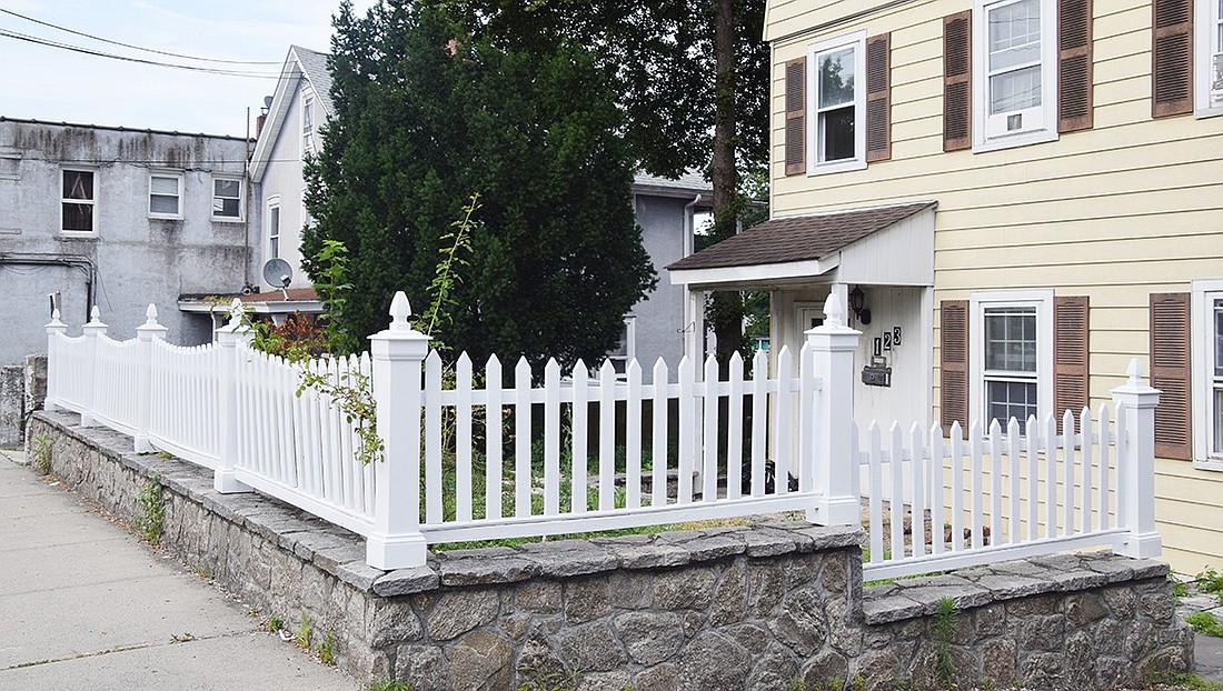 The newly painted fence surrounding 123 Pearl St. as it looks today.