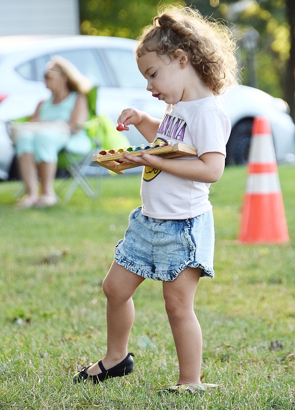 After the band Andrea and the Armenian Rug Riders offers toy instruments to children in Pine Ridge Park, Maddie Karasik dances and plays along on a colorful xylophone as they sing groovy versions of kids’ songs. The Rye Brook 3-year-old is attending the first free concert in the Village’s Music in the Park summer series on July 10.