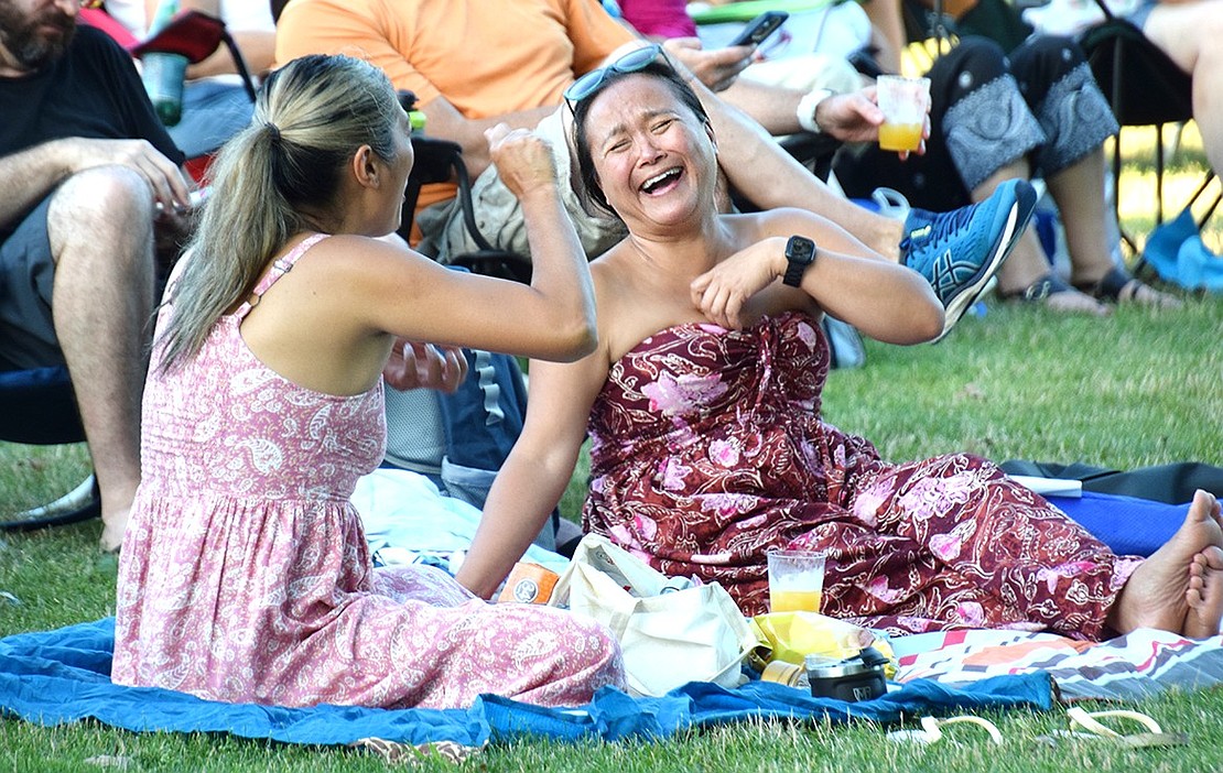 Catching up with a wholesome laugh, Betsy Brown Road resident Mary Barbagli (right) is all smiles as she chats with her friend Taylor Gutierrez, a Rye Brook Recreation Advisory Council member. The Rye Brook residents are enjoying a light picnic at the Village’s first Music in the Park concert of the summer on July 10.