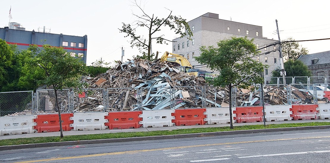 By Tuesday, July 16, the two-story wooden residential buildings with one-story storefronts facing Westchester Avenue that stood for decades across from The Capitol Theatre had been reduced to this large pile of building materials. A 12-story mixed-use building with 223 residential units and retail on the first floor has been approved for the 140-150 Westchester Ave. site.