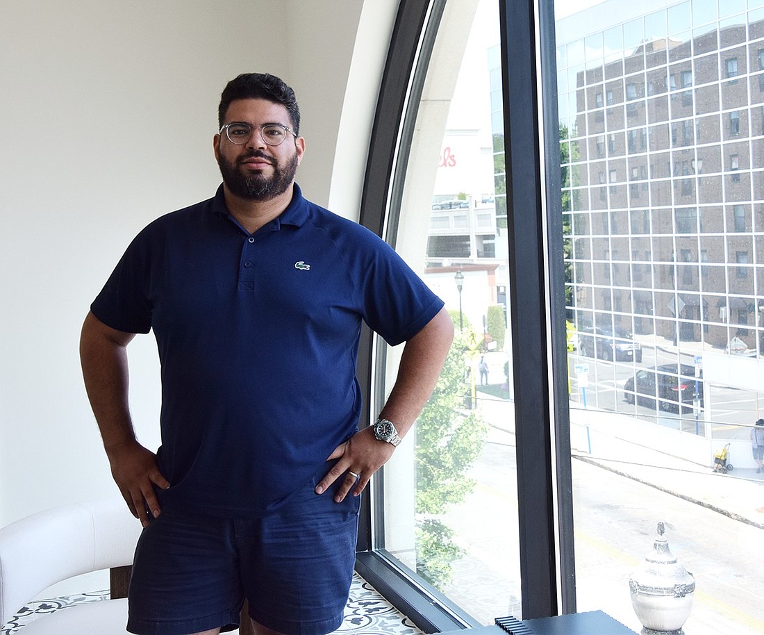 David Cortez, a co-founder of Foretold, poses for a photo in front of the company’s lobby window at 108 S. Main St. on Tuesday, July 16. His startup, which aims to assist developers seeking funding for their construction projects, was selected to participate in Westchester County’s Element 46 Tech Accelerator, a 12-week program leading to a presentation for potential investors in June.