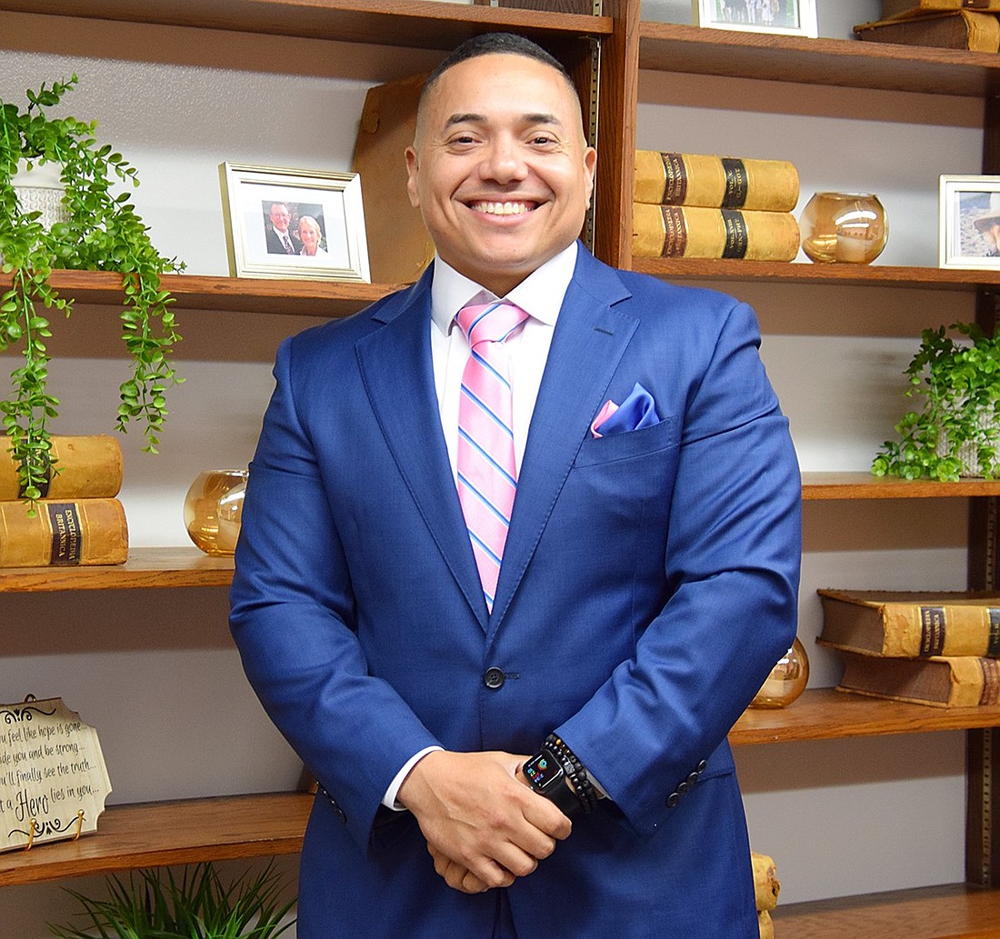 A big smile stretches across Juan Sanchez’s face as he poses for a picture on Monday, July 15, after discussing his new role as the Port Chester Schools executive director of human relations.