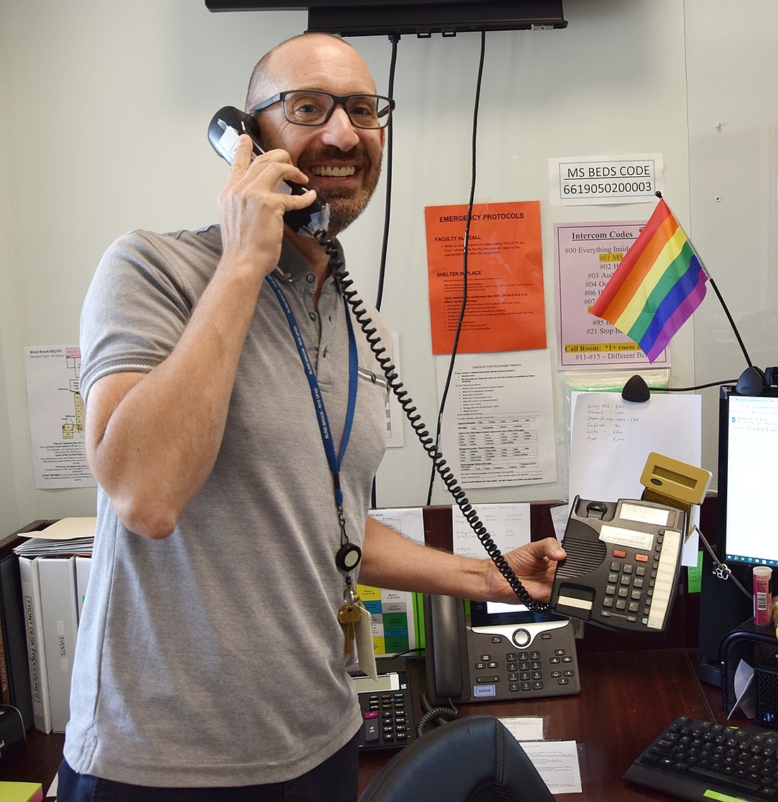 Blind Brook Middle School Principal Seth Horowitz poses for a photo on June 21 with the only phone in the building that can be used to make announcements using the PA system, which will be replaced by the start of the new school year. The $464,000 project will modernize the unit for convenience and safety purposes.