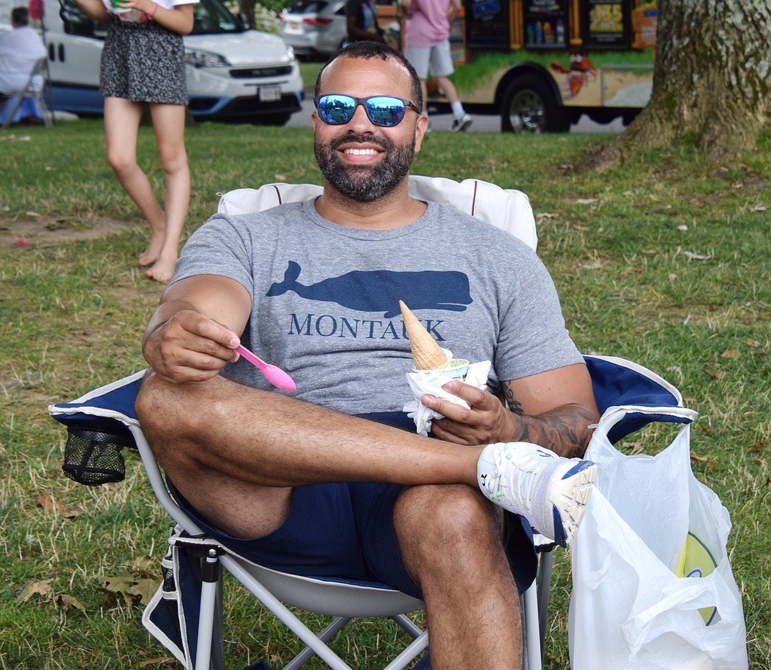 Port Chester Middle School Principal Bryant Romano gets into the summer vacation mood after picking up a sugary treat from Bona Bona Ice Cream.