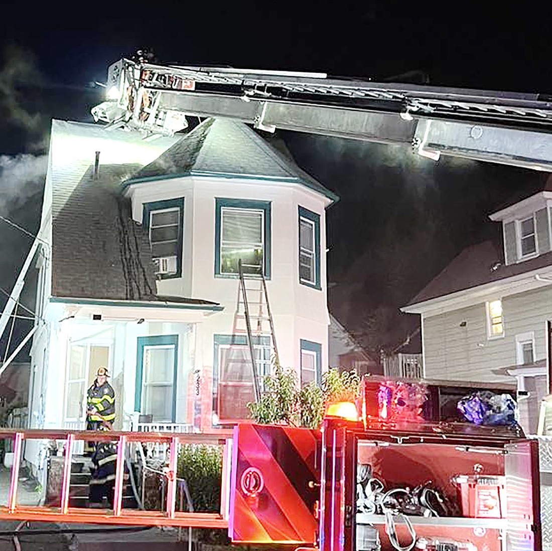 Port Chester firefighters use ladders to investigate smoke coming from the roof of a home at 233 Seymour Rd. on July 15. It was one of the two working fires the department extinguished last week.