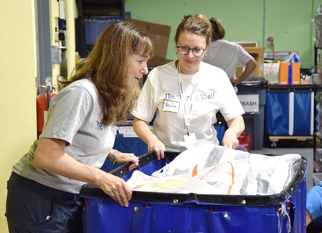 The Sharing Shelf Executive Director Deborah Blatt (left) and Assistant Director for Volunteers and Community Engagement Karina Tarnawsky wheel a cart of supplies to the packers. Blatt said every year Backpacks to School serves at least one student from every school district in Westchester, and this year, the non-profit is seeking monetary donations as they’re $20,000 under their goal to fund the initiative. To donate, go to sharingshelf.org