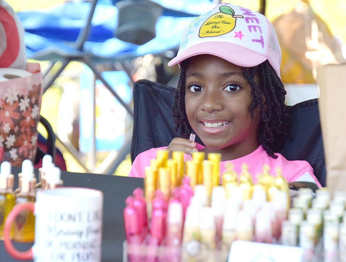 Stamford, Conn., 8-year-old Maliah Armstead happily attends the booth her mother Alecia, a Port Chester native visiting home for Unity Day, set up to sell crafts and handmade essential oils.