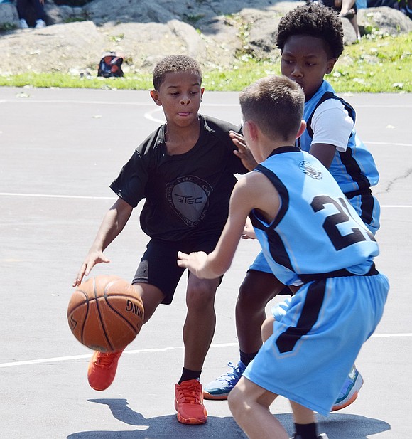 Demetrius Ephraim, a rising Port Chester fourth-grader playing with the Beyond the Game Connection team, weaves through opponents on the Frenji Sports Academy team during a basketball game at Unity Day on Saturday, Aug. 10.