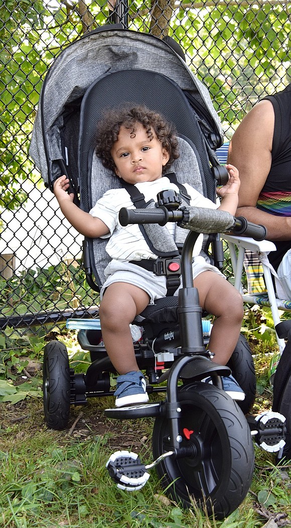 Keeping cool in the heat, 1-year-old Traverse Avenue resident Jayden Morel posts up in a shady spot in the park with his family.