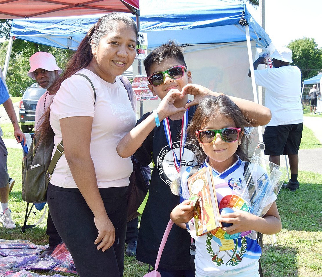 Decked out in fun, colorful merch from various vendors, Port Chester resident Eva Pachero and her children Christian, 10, and Ashley Hernandez, 6, enjoy some family bonding.