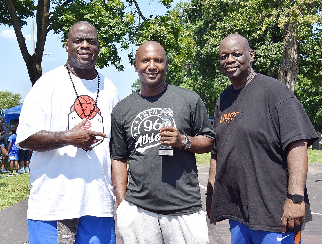 Lou (left) and Derek Vincent, the founders of Unity Day, flank Benjamin Carter to pose for a photo after honoring him between tournament games. Carter of Greenburgh is a “longtime friend and supporter” of Unity Day who founded the Westchester youth basketball program called the Frenji Sports Academy, Derek said.