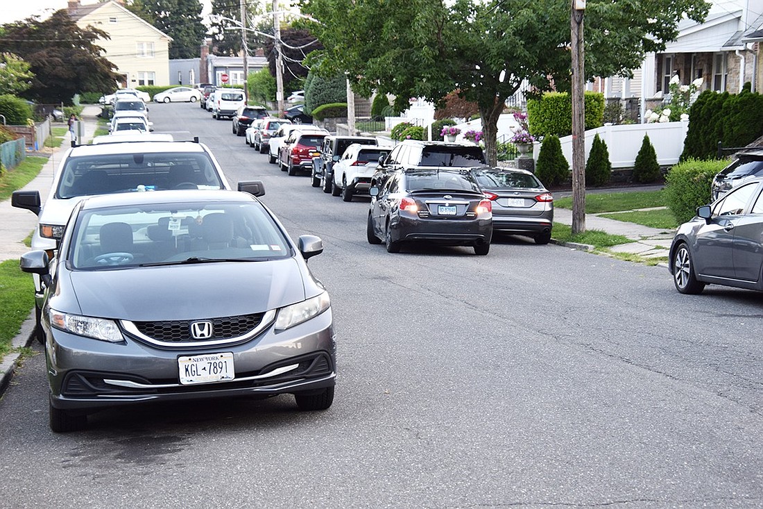 A driver backs into a parking space in front of a driveway on a packed Fairview Place off South Regent Street on an August evening. A survey of parking in the Washington Park neighborhood found there are 1,400 parking spaces available and 111% of those spaces were being used during nighttime hours.