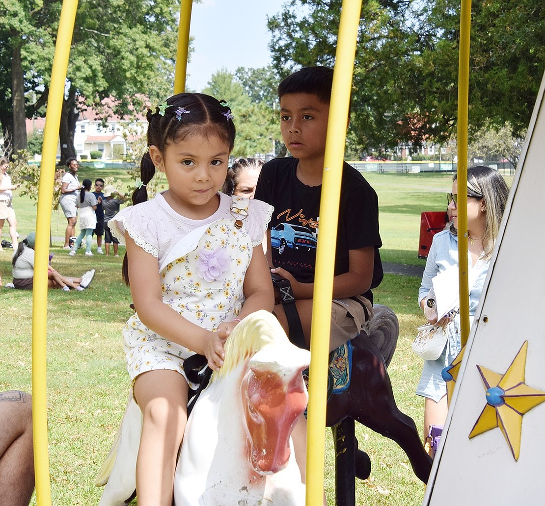 Nothing gets past Frida Velez. The 4-year-old South Regent Street resident suspiciously eyes the camera as she takes a ride on the merry-go-round.