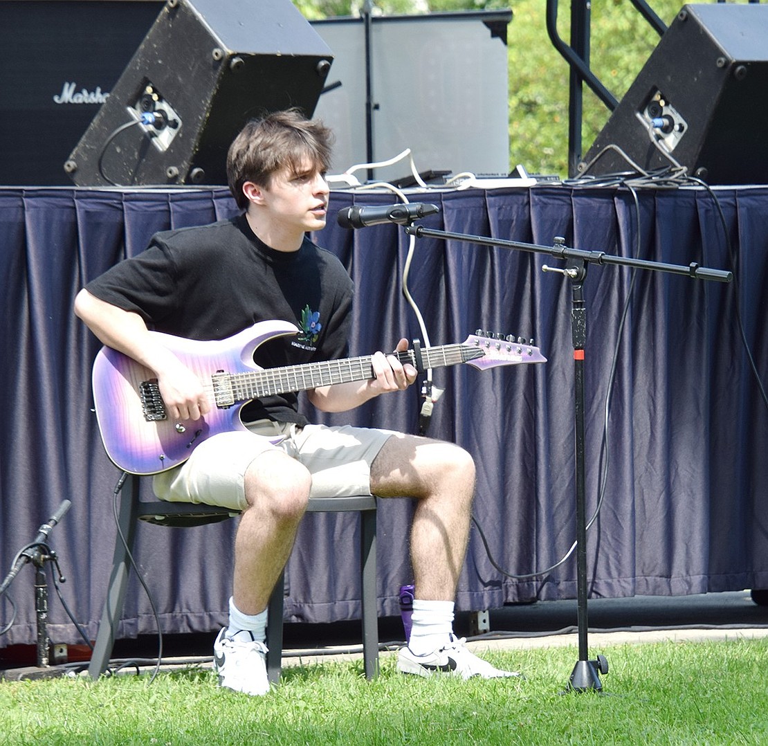 Rye resident Peter Lovitt, 17, serenades attendees with renditions of songs like “Wonderwall” by Oasis.