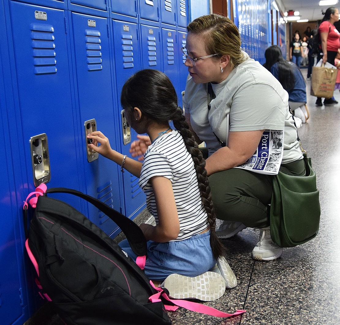 Bent Avenue resident Valentina Muratalla practices getting her newly assigned locker open with her mom Yesenia Bautista.