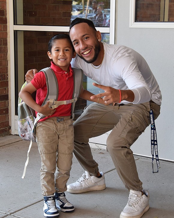 “Looking good, Emiliano,” says King Street School Teacher’s Aide Jonathan Garces, greeting first-grader Emiliano Najera, 5, with the compliment.