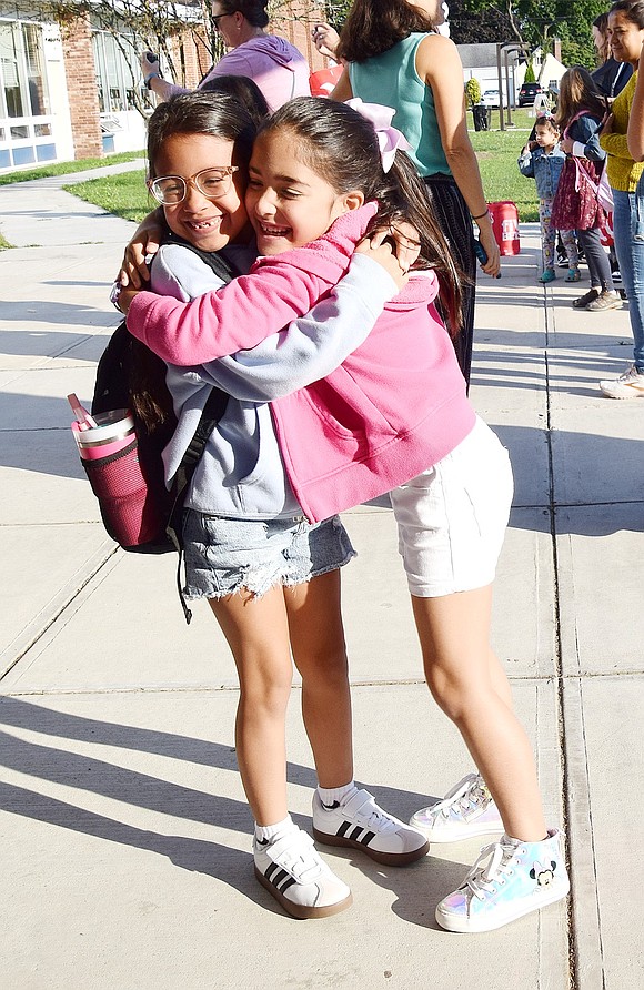 Alliah Aguilar (left) and Heidi Carneiro embrace after racing toward each other before their first day as classmates in Maria Sileo’s third-grade class at King Street School begins on Tuesday, Sept. 3. The two were among the hundreds of students across the Port Chester School District officially kicking off the 2024-25 year that day.