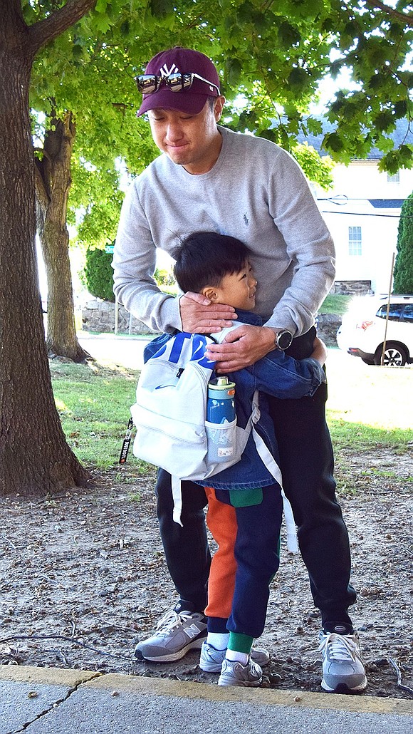 Hayul Chung, 4, hugs his dad Sang Hoon farewell before beginning his academic career as a kindergartner at Thomas Edison School.