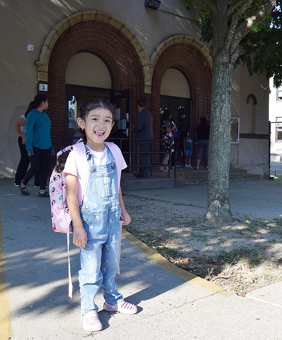 On her first day of school—ever—Orchard Street kindergartner Danieal Loaiza, 5, breaks out into a big smile while standing in front of Thomas Edison School.