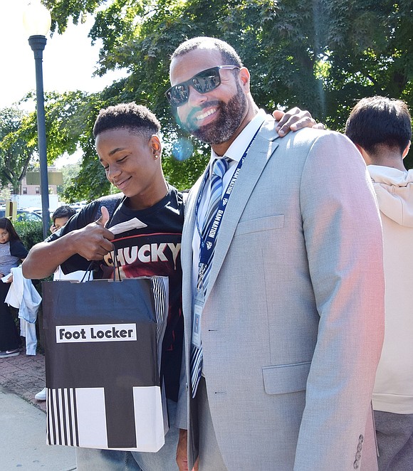 After racing through the crowd of middle schoolers to find him, eighth-grader Jorge Herrera Rincon poses for a photo with his building principal Bryant Romano.