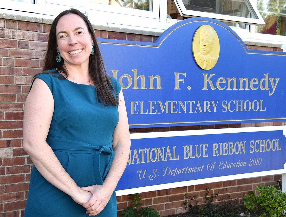 Colleen Moore, the new John F. Kennedy Elementary School principal, poses for a photo outside her building on Thursday, Sept. 5, after discussing her motivation to embolden a sense of community in her students.