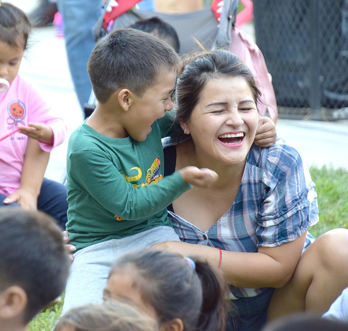 Wild with giggles during a clown show, Adam Concha, a 4-year-old Port Chester Schools Universal Pre-Kindergarten student, redirects his energy affectionately toward his mother Anny Ojeda. The entertainment was provided at the district’s first Back to School Bash on Thursday, Sept. 5, an event that invited Ramily members of all ages to the middle school to celebrate the start of the 2024-25 school year.