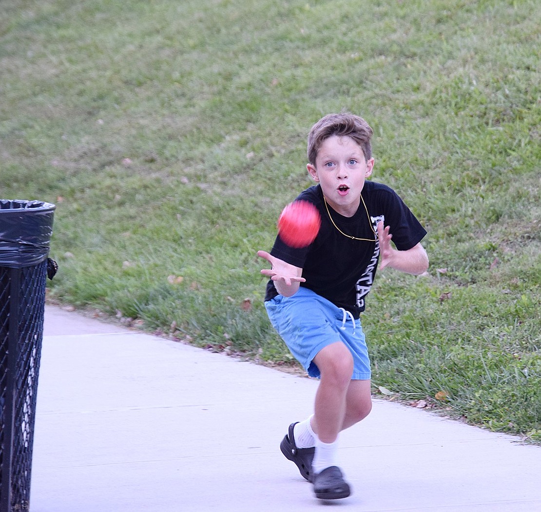 Perhaps a future Rams athlete, Park Avenue School third-grader Christopher Tevnan dives for a ball while playing catch with family members.