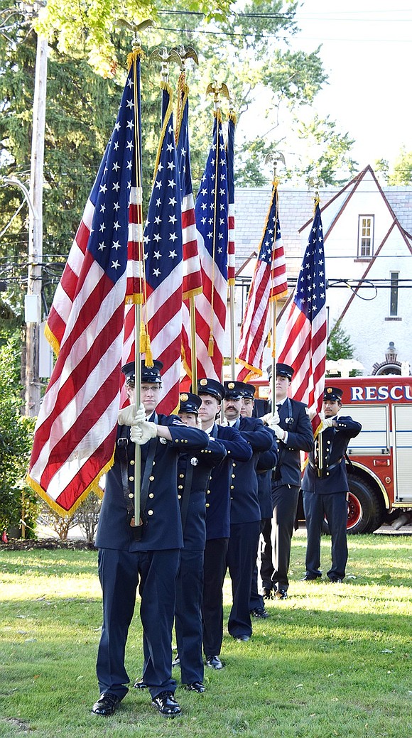 In formal attire, Port Chester Volunteer Fire Department member Brian Benjamin, of Fire Patrol & Rescue 40, leads the color guard at the ceremony.