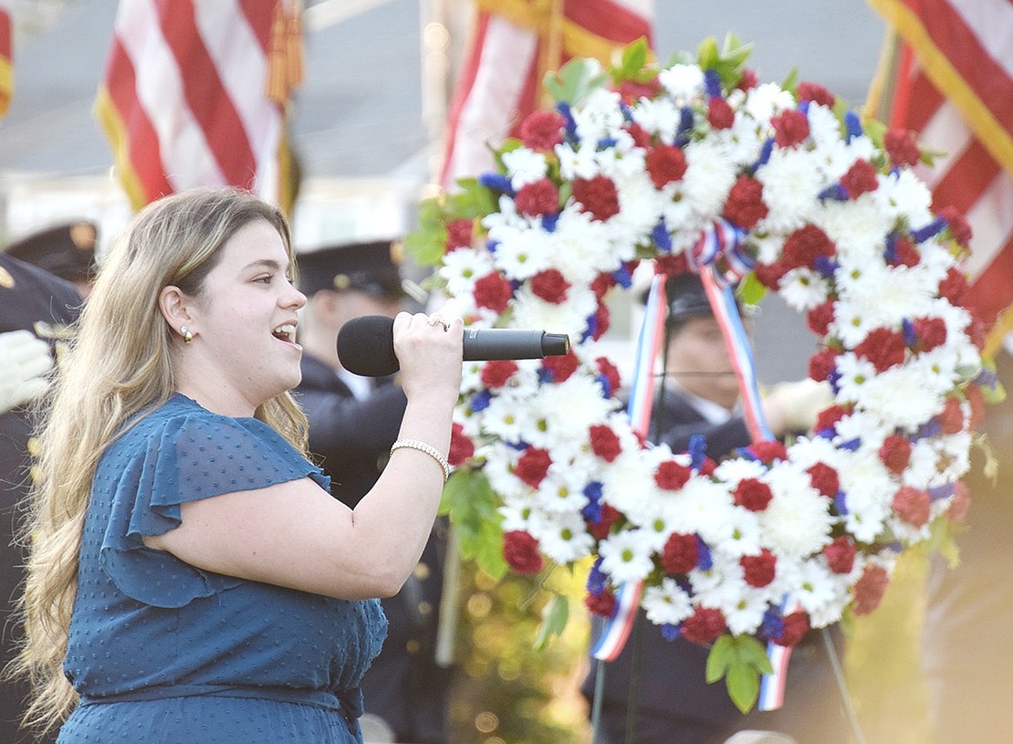 Port Chester Middle School teacher and Village native Rosie Veltri performs her rendition of the national anthem at the 9/11 memorial ceremony at Lyon Park commemorating the 23rd anniversary of the Sept. 11 terrorist attacks.