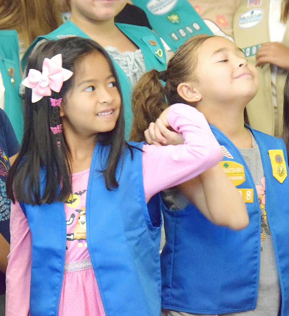 Daisy Scouts Juliet Horna (left) and Rey Altreche of Troop 02908 hold hands during the start of the Girl Scout year celebration at the Girl Scout House in Lyon Park on Saturday, Sept. 14. On top of celebrating the achievements and promotion of current Scouts, the Port Chester/Rye Brook Girl Scout event welcomed three new troops to the community.