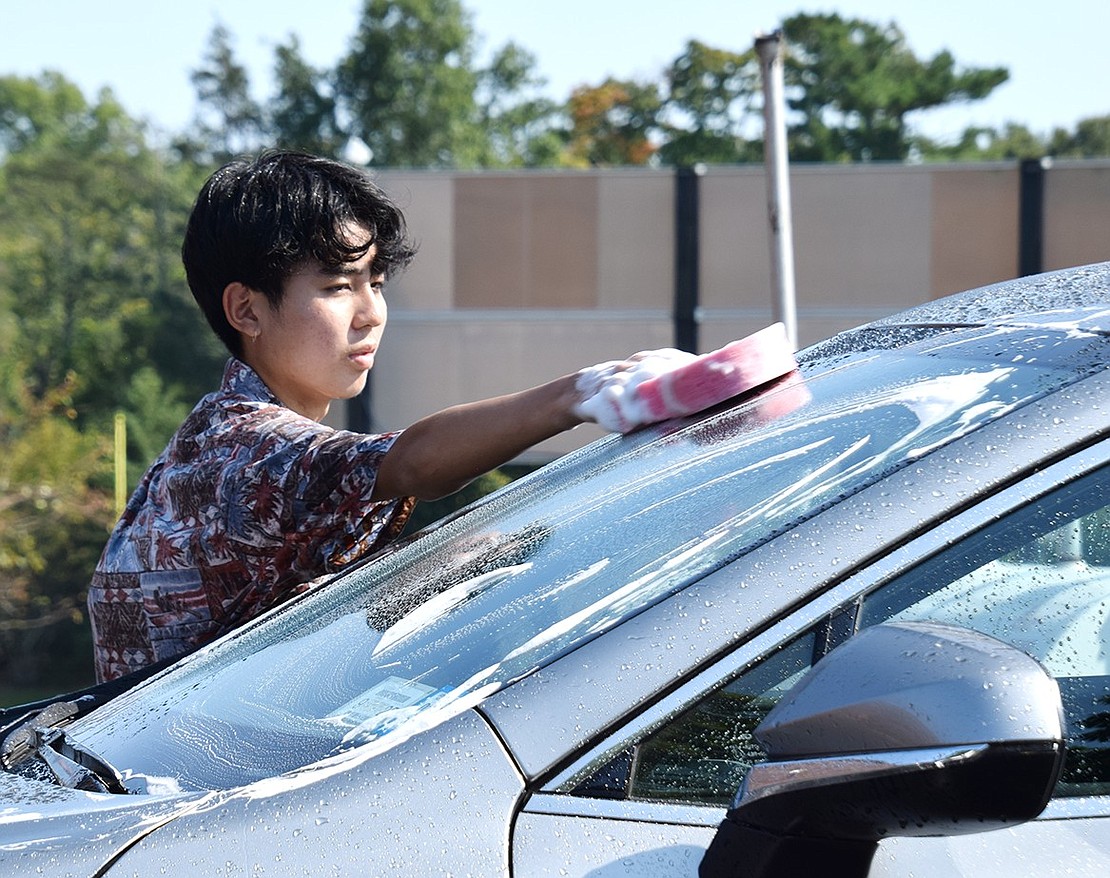 In 80-degree weather, Milestone Road resident Hiro Shizuka, a senior, puts in his time washing cars for the cause.