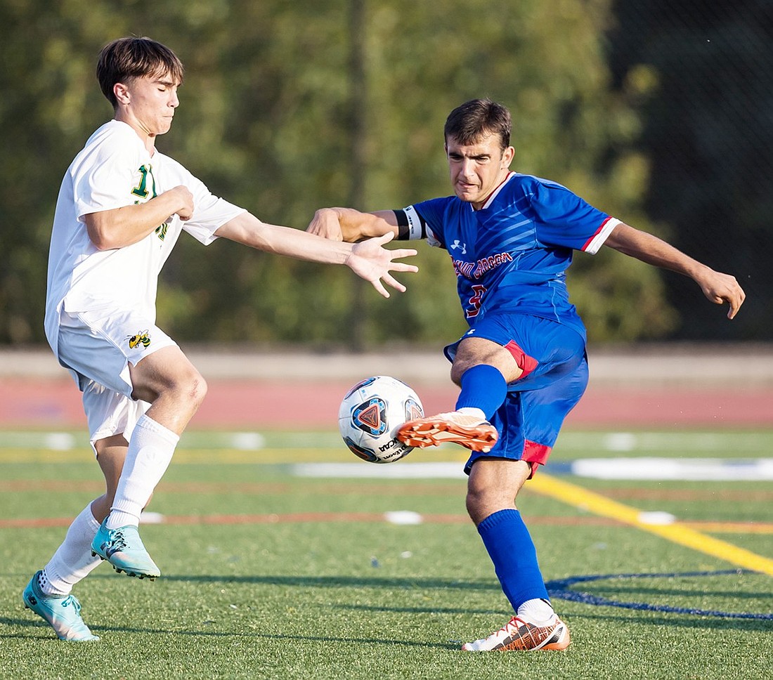 Captain Nico Palacios strikes the ball at a Hastings defender in Blind Brook’s Friday, Sept. 13 home game which ended in a 2-0 victory for the Trojans. Palacios scored one of those two goals.