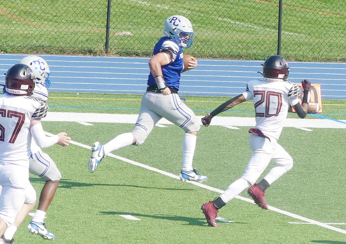 Ram John Pauletti breaks away from Magnus defenders on his 60-yard touchdown run, one of his three touchdowns during Port Chester’s 27-14 home win last Friday (9/13).